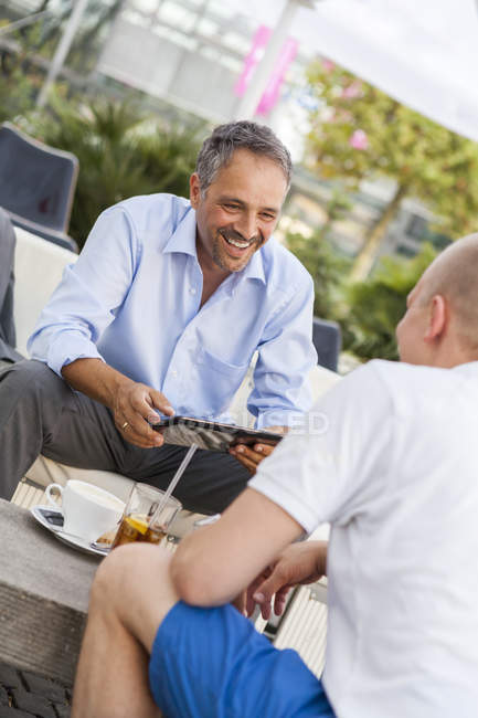 Portrait of man communicating with his friend in a cafe — Stock Photo