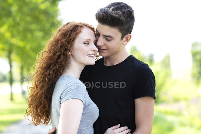 Teenage couple in love — sky, tenderness - Stock Photo | #179897954