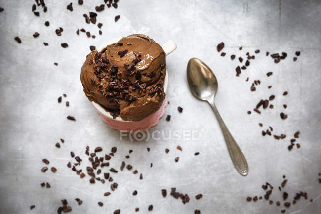 Cup of vegan chocolate banana ice cream decorated with cacao nibs — Stock Photo