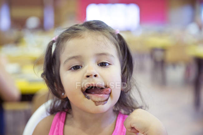 Portrait of little girl covered with ice cream — Stock Photo