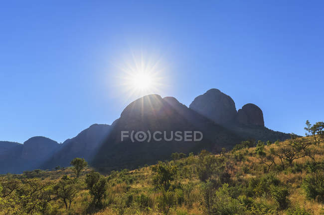 Africa, South Africa, Marakele National Park, Waterberg mountain range against the sun — Stock Photo