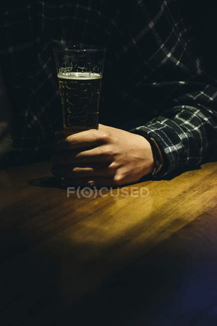 Кадроване зображення, рукою людини з келих пива в м. бар — стокове фото