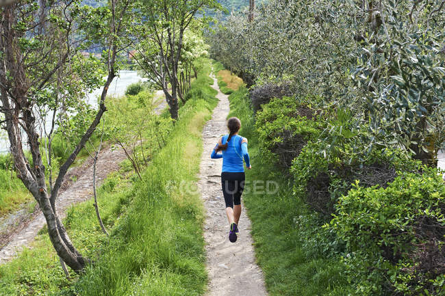 Woman running near Lake Garda — Stock Photo