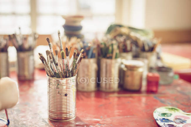 Close-up of paintbrush in metal jar on table — Stock Photo