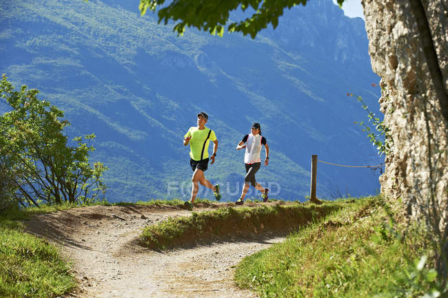 Couple running near Lake Garda — Stock Photo