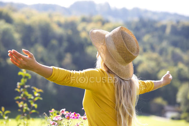 Relaxed teenage girl with outstretched arms — Stock Photo
