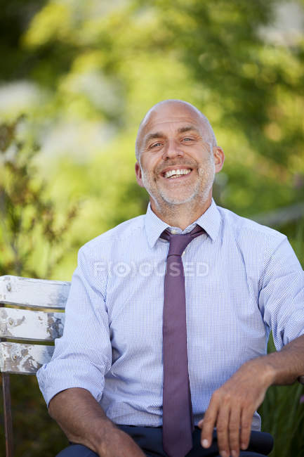 Portrait of laughing businessman in nature — Stock Photo