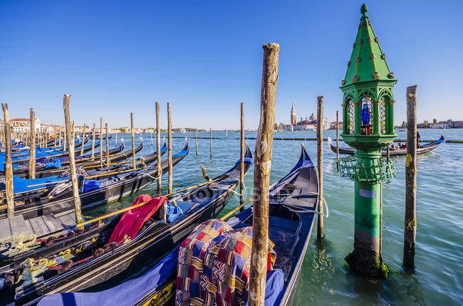 Italy, Venice, colorful gondolas at a pier in sunslight — Stock Photo