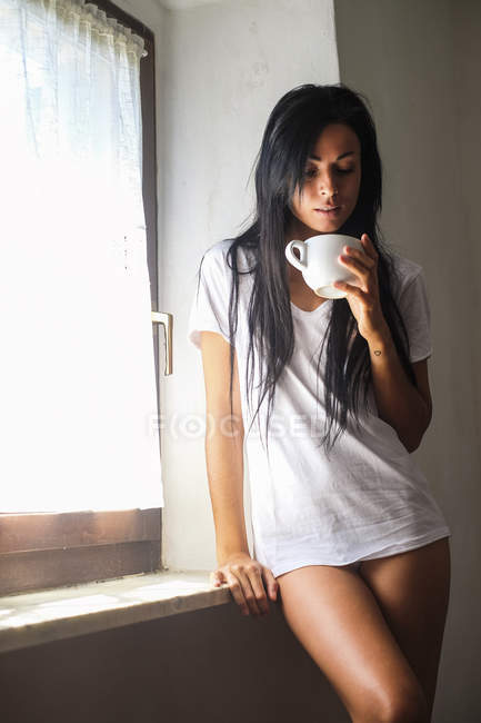 focused_180509832-stock-photo-young-attractive-woman-drinking-coffee.jpg