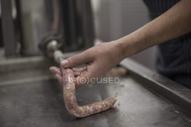 Butcher making sausages in butchery, closeup — Stock Photo