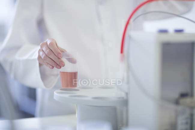 Cropped image of scientist in lab working with liquid — Stock Photo