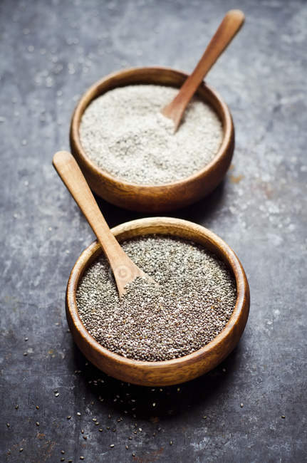 Wooden bowls of black and white chia seeds — Stock Photo