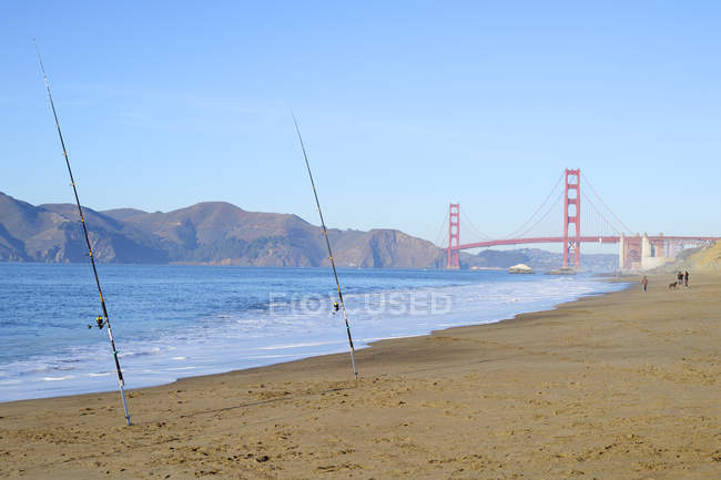 USA, California, San Francisco, fishing rods at Baker Beach and Golden Gate Bridge — Stock Photo
