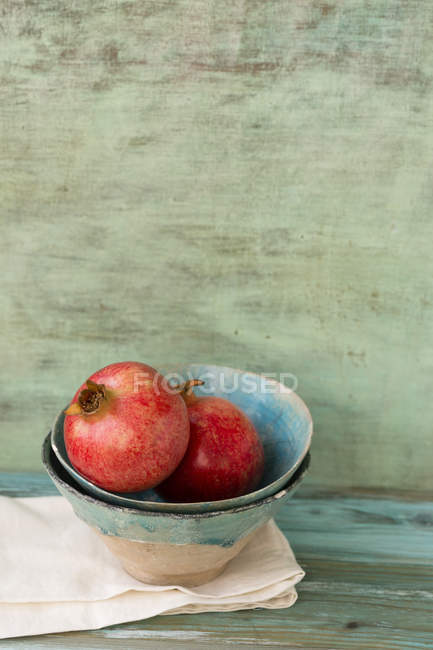 Bowl with two pomegranates — Stock Photo