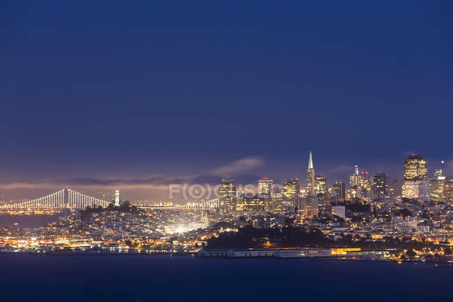 EUA, Califórnia, São Francisco, skyline e Oakland Bay Bridge na hora azul — Fotografia de Stock