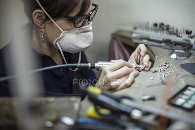 Vista de primer plano de orfebre trabajando en joyería en taller - foto de stock