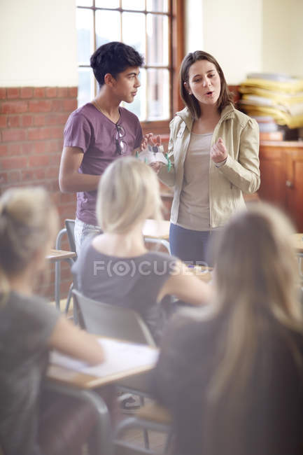 Young students holding a presentation in classroom — Stock Photo