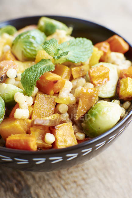 Roasted sweet potato, butternut squash and brussel sprouts in bowl — Stock Photo