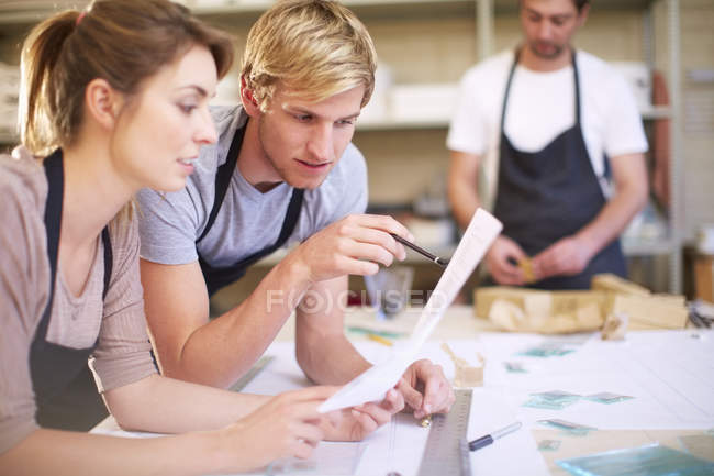 Couple in a workshop manufacturing stained glass — Stock Photo