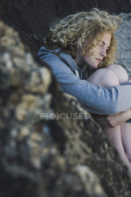 Teenage girl sitting on the beach — Stock Photo