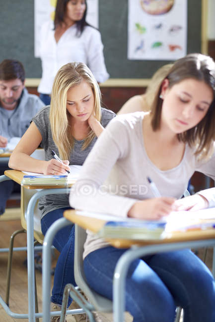 Cropped Portrait Of Students In Classroom Having An Exam Education Caucasian Appearance Stock Photo 181040986