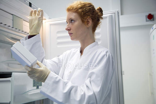Female natural scientist controlling a test in biochemistry laboratory — Stock Photo