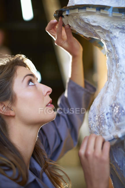 Young craftswoman preparing rubber mold for bronze sculpture — Stock Photo