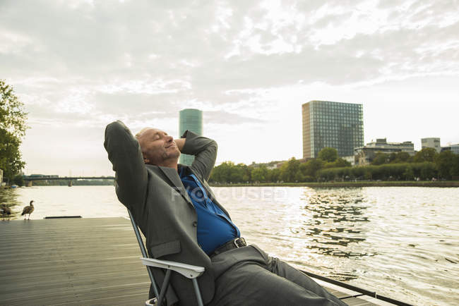 Germany, Frankfurt, relaxed businessman at river Main — Stock Photo