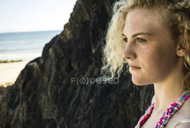 Portrait of teenage girl on the beach looking at distance — Stock Photo