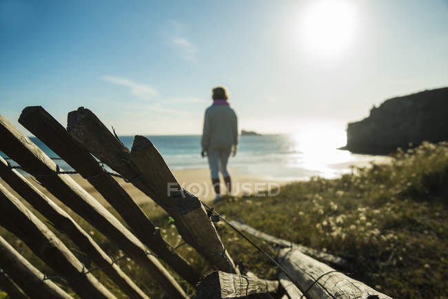 France, Brittany, Camaret-sur-Mer, senior woman standing at the coast — Stock Photo
