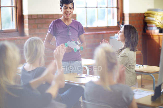 Female students applauding after presentation in classroom — Stock Photo