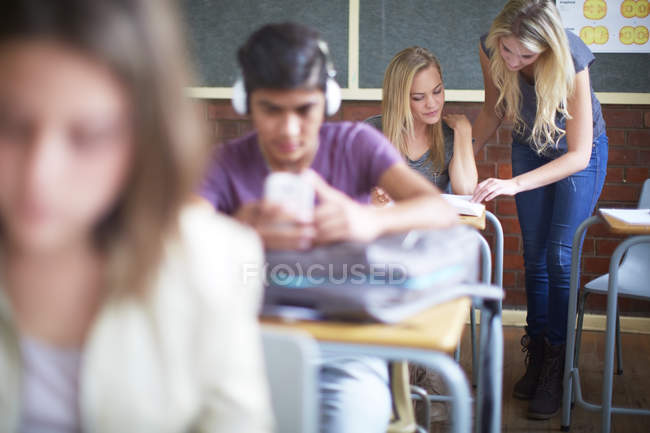 Cropped portrait of teenage students in classroom — Stock Photo