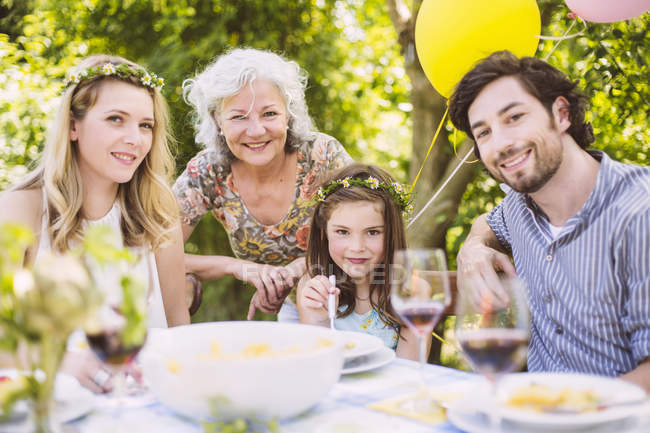 Portrait of happy family of three generations on a garden party — Stock Photo