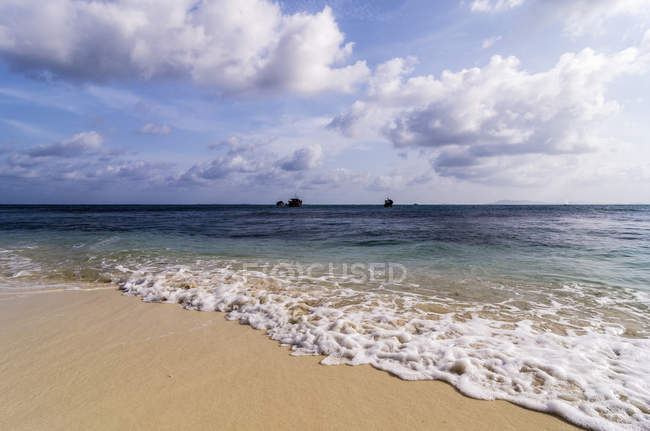 Indonesia, Riau Islands, Bintan, Nikoi Island, Beach with fishing boats in background — Stock Photo