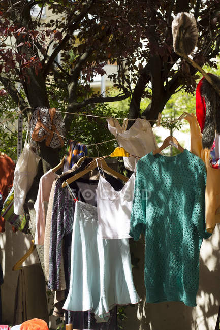 Clothes at a flea market outdoors — clothing, choice - Stock Photo |  #181294340