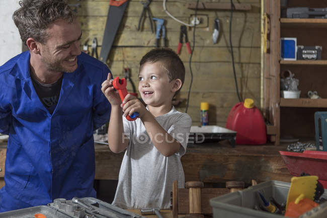 Father and son working in home garage — Stock Photo