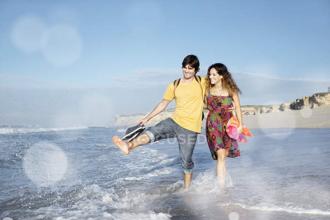 South Africa, happy couple wading in the ocean — Stock Photo