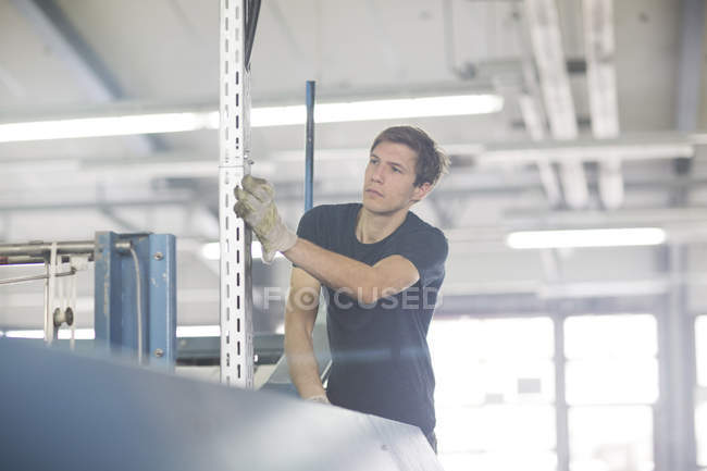 Technician in factory controlling machine — Stock Photo