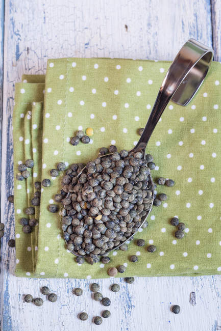 Spoon of Alb Leisa lentils on polka dot cloth — Stock Photo