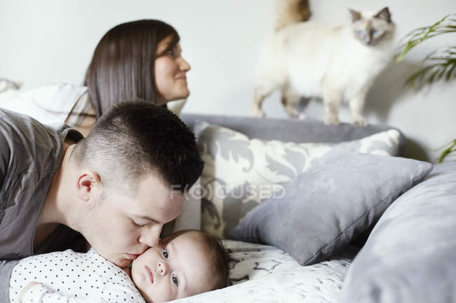 Young family with cat in living room — Stock Photo