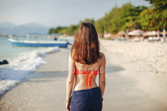 Indonesia, Gili Islands, woman standing on the beach, back view — Stock Photo