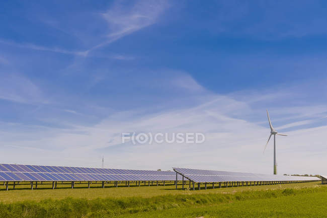 Germany, Schleswig-Holstein, View of solar panel and wind turbine in ...