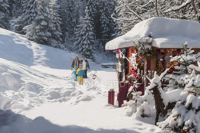 Austria, Altenmarkt, family walking at Christmas market — Stock Photo