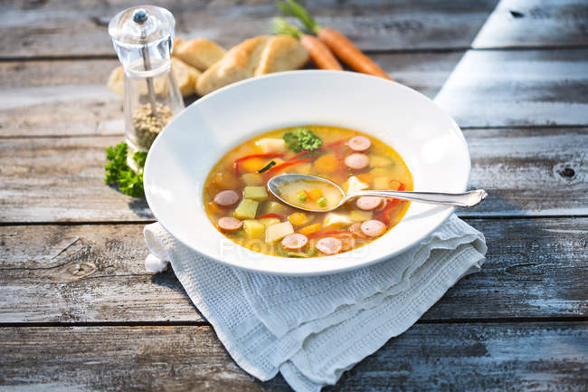 Vegetable soup with sausage in soup dish — Stock Photo