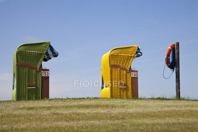 Germany, Lower Saxony, Eastern Friesland, Butjadingen, Burhave, two roofed wicker beach chairs — Stock Photo