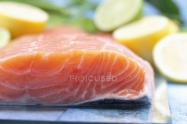 Salmon fillet on blue wooden table — Stock Photo