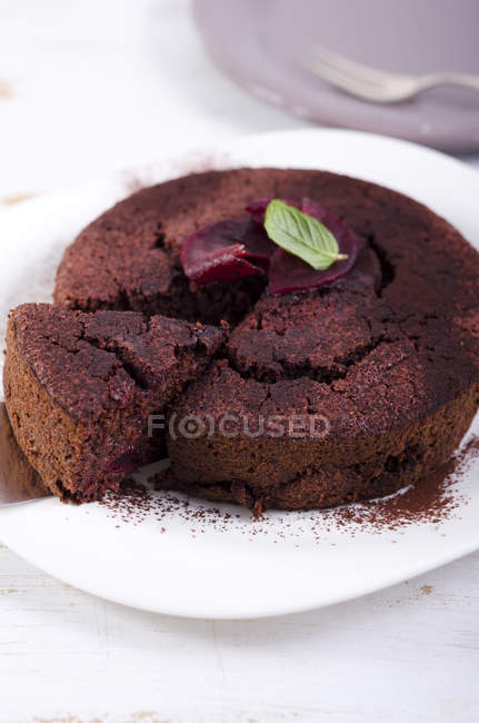 Chocolate cake with slice of beetroot on white plate — Stock Photo