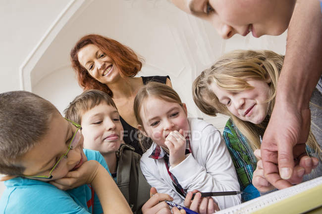 Close-up of kids learning with teacher during lesson — Stock Photo