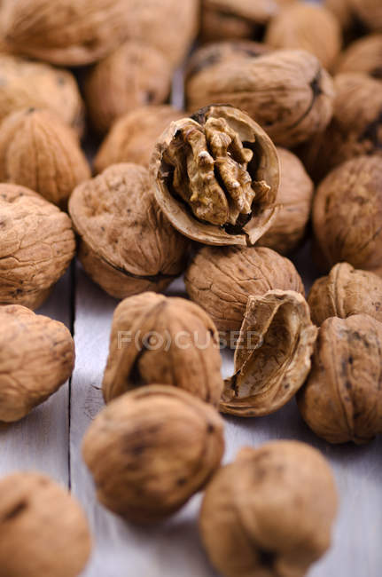Walnuts on white wooden table, studio shot — Stock Photo
