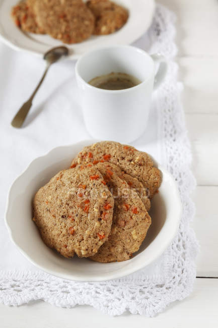 Carrot Almond whole grain Cookies and coffee cup on white napkin — Stock Photo